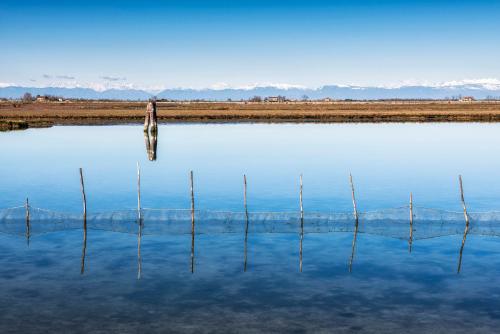 a group of poles sticking out of the water at Jesolo Happy Beach House - Host Solution in Lido di Jesolo
