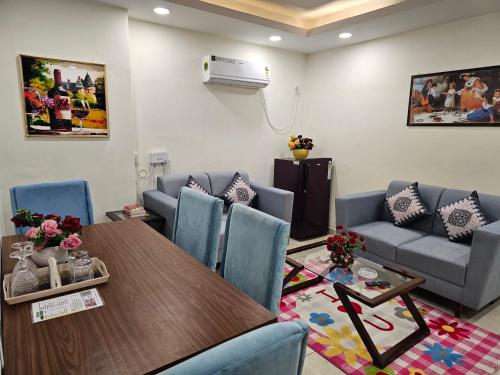 a room with a table and chairs and a couch at Ultra Luxury 1Bhk 1121 Flat By Bliss Stay in Ghaggar