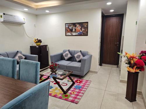 a living room with a couch and a table at Ultra Luxury 1Bhk 1121 Flat By Bliss Stay in Ghaggar