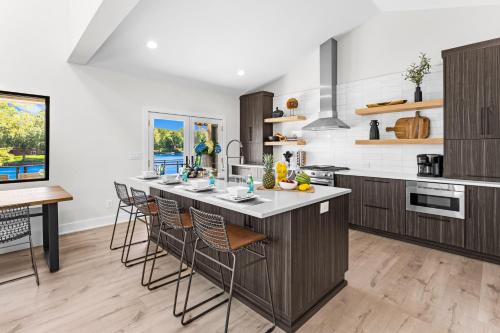 a kitchen with a large island with bar stools at Fox Run LKN in Denver