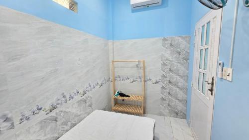 a small room with a bed and a mirror at Dan Family Homestay in Ấp Bình Hưng