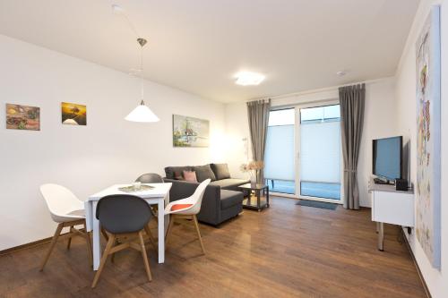 a living room with a couch and a table at Am Hafen3 in Röbel