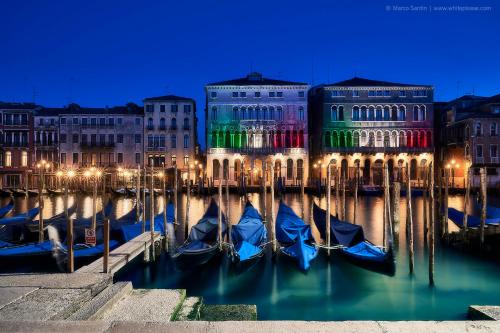 a group of boats in the water in front of buildings at Jesolo Sun Beach House - Host Solution in Lido di Jesolo