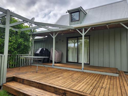 a pergola over a deck on a house at Hahei Holiday Haven in Hahei