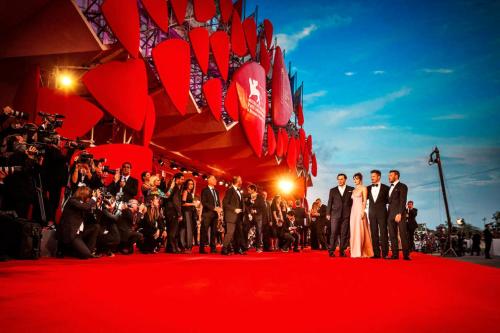 a group of people standing on a red carpet at Jesolo Village Beach House - Host Solution in Lido di Jesolo