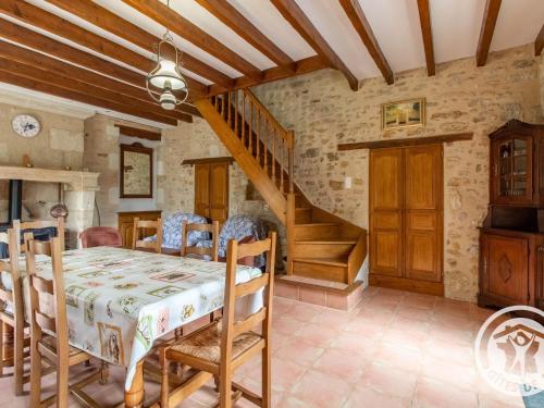 une salle à manger avec une table et un escalier dans l'établissement Gîte charmant à Saint-Georges près de Doué-en-Anjou - FR-1-622-98, à Méa