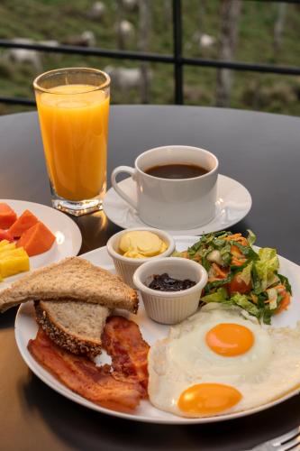 a plate of breakfast food with eggs and a cup of coffee at Cabañas Vista Verde opción con jacuzzi in San Vito