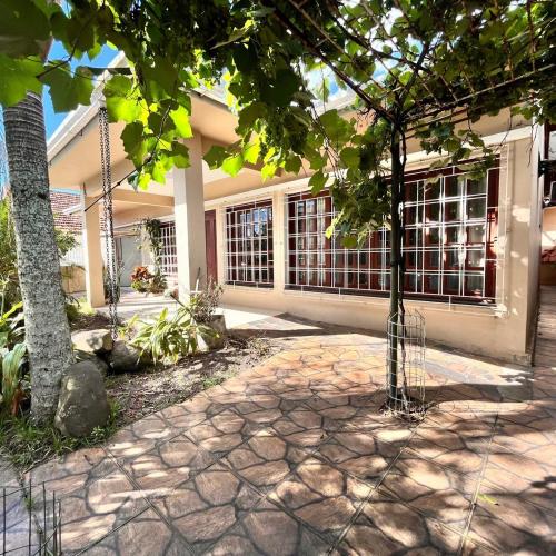 a house with a tree in front of it at Casavivi in Tramandaí