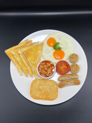 a plate of breakfast food with eggs bread and toast at Poolside Villa in Phnom Penh
