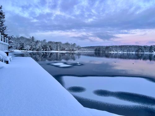 a view of a lake with snow on the water at Bonnie View Inn in Haliburton