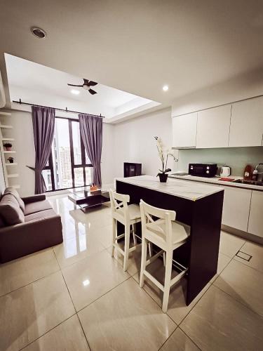 a kitchen with a table and chairs in a room at SS KL Sentral by NomadNest in Kuala Lumpur