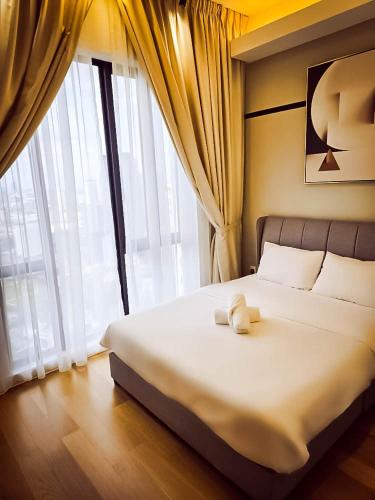 a bed in a room with a large window at SS KL Sentral by NomadNest in Kuala Lumpur