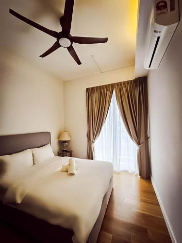 a bedroom with a large white bed with a ceiling fan at SS KL Sentral by NomadNest in Kuala Lumpur