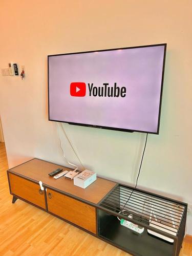 a television screen with a youtube sign on a wall at imperium residence kuantan in Kuantan