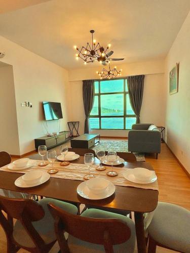 a dining room with a table with wine glasses on it at imperium residence kuantan in Kuantan