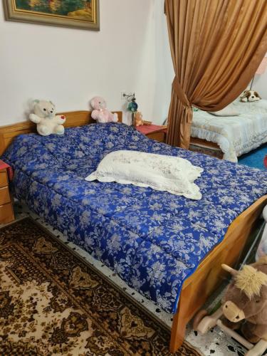 a bedroom with a bed with stuffed animals on it at Villa George - Family Holidays in Nea Makri