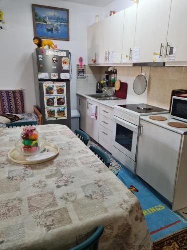 a kitchen with a table and a refrigerator at Villa George - Family Holidays in Nea Makri