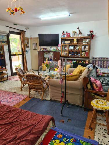 a living room with a couch and a table at Villa George - Family Holidays in Nea Makri