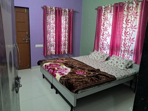a bed in a room with purple walls and windows at A C Room For Couple with Refrigerator, Microwave, RO Water in Marwad
