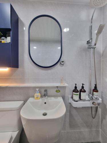 a bathroom with a white sink and a mirror at 정스테이 서울 잠실 롯데월드 kspodome 아산병원 길동 코엑스 성수명동강남동대문 in Seoul