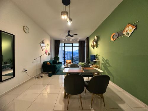 a living room with green walls and a table and chairs at New 2BR Georgetown Warm and Lovely Homestay 10pax-无敌美景两房民宿 Beacon Executive Suite in George Town