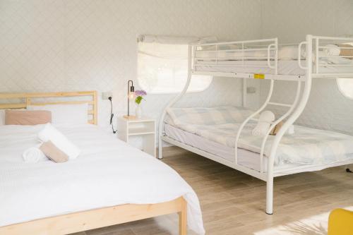 a bedroom with two bunk beds and a table at zhus garden in Kilsyth