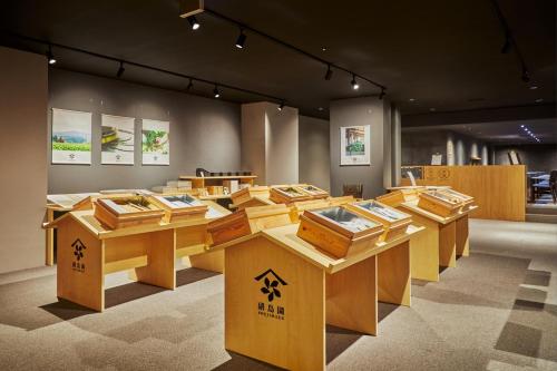 a room with wooden tables with books on them at Wataya Besso in Ureshino