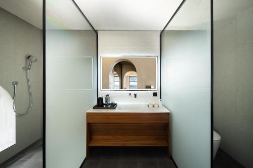 a bathroom with a sink and a mirror at Erhai Seaview Garden Villa &Dali Airport in Dali