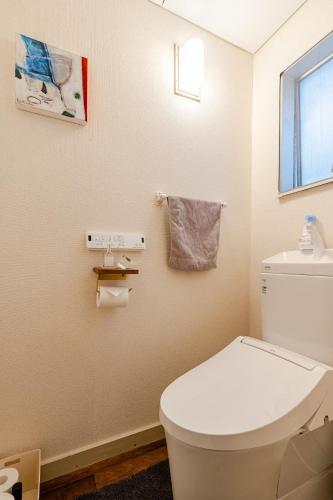 a bathroom with a white toilet and a window at Tokyo Base Meguro Room #301 in Tokyo