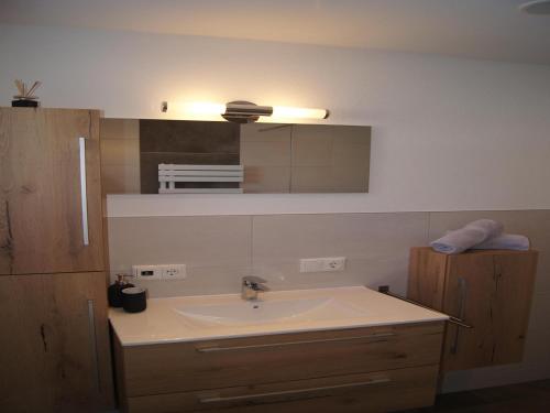 a bathroom with a sink and a mirror at Holiday apartment near ski area in Aschau