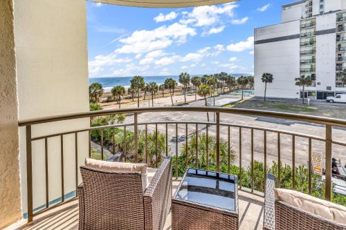 a balcony with chairs and a view of the ocean at Spectacular Oceanview Condos in Myrtle Beach