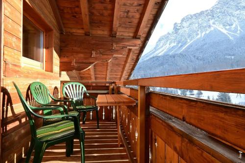a balcony with chairs and a table and a window at Sonnenspitze in Biberwier
