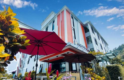 a building with two red umbrellas in front of it at Golden sand khaolak Resort in Khao Lak