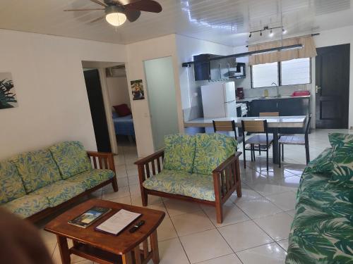 a living room with a couch and chairs and a table at Fare Ara Location Huahine in Fare