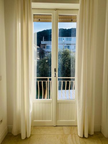 an open door with a view of a balcony at Maison Sciscì in San Felice Circeo