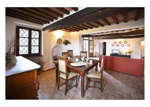 a kitchen and dining room with a table and chairs at Podere Suvignano in Murlo