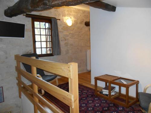 a room with a wooden bunk bed and a window at Sous les Marronniers in Petit-Palais-et-Cornemps