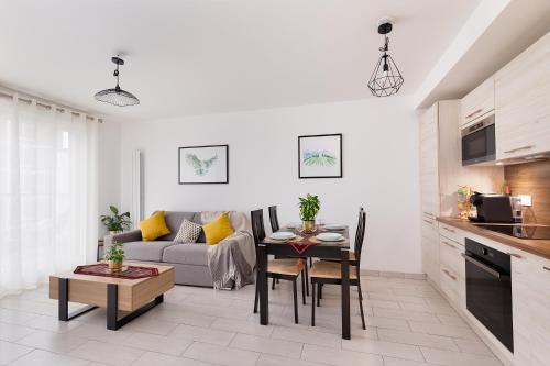 a living room with a couch and a table at Chic & Cozy Living - Near Heart of Paris in Clichy