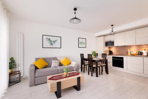 a living room with a couch and a table at Chic & Cozy Living - Near Heart of Paris in Clichy