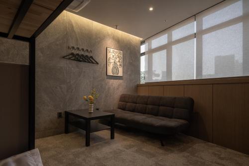 a living room with a couch and a table at Extay Dongdaemun in Seoul