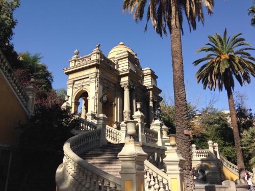 a building with a staircase and a palm tree at Azzaí Bellas Artes in Santiago