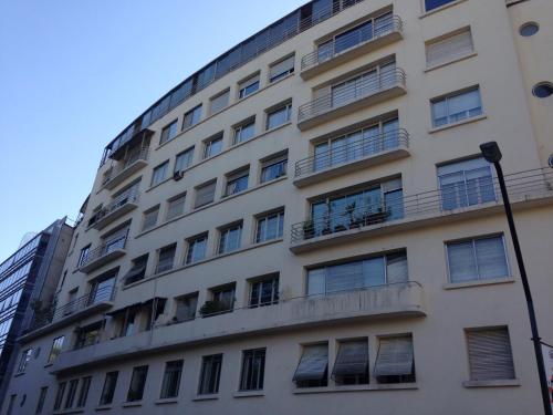 a tall white building with balconies on it at Azzaí Bellas Artes in Santiago