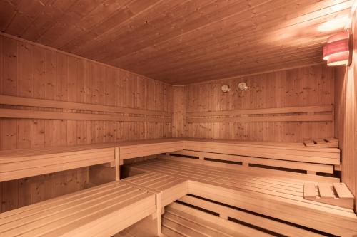 a large wooden sauna with wooden benches in it at SCHMID Rooms & Apartments in Ischgl