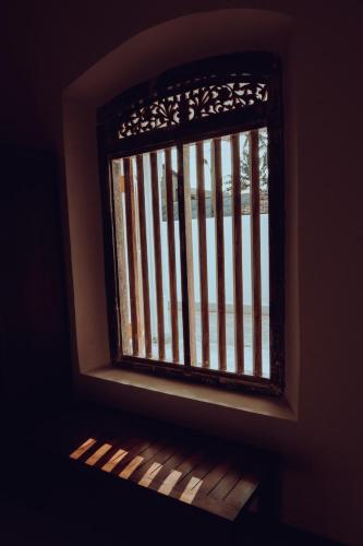 a window with an american flag on it at White on White in Hikkaduwa