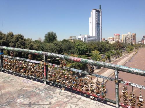 a bunch of padlocks on a fence in a city at Azzaí Bellas Artes in Santiago