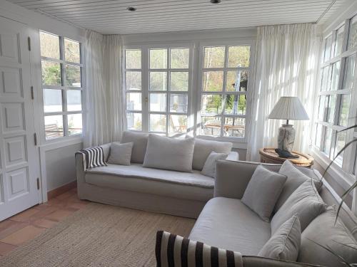 a living room with a white couch and windows at GURAH Boutique Apartments in Bakio