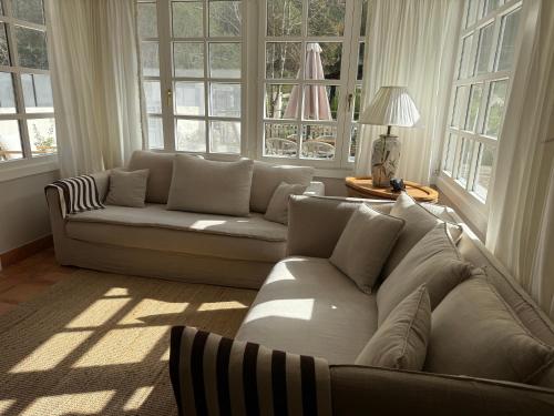 a living room with a white couch and windows at GURAH Boutique Apartments in Bakio