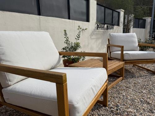 two chairs and a coffee table on a patio at GURAH Boutique Apartments in Bakio