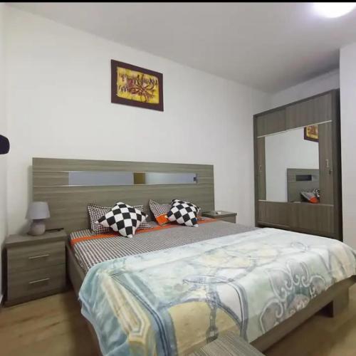 a bedroom with a large bed with pillows on it at Appartement de luxe à louer in Dakar