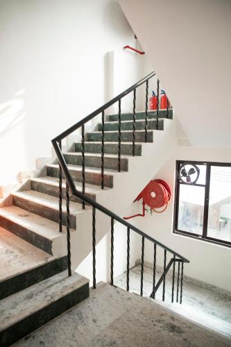 a staircase in a house with a painting on the wall at Family Stay New Delhi by Sona Hight in New Delhi